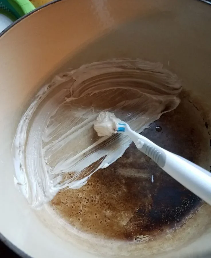 how to clean enameled cast iron dutch oven and remove brown baked-on stains on interior white porcelain enamel