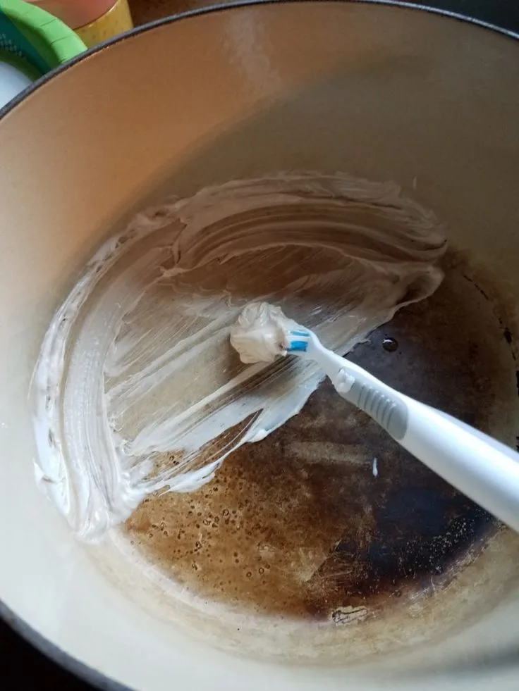 how to clean enameled cast iron dutch oven and remove brown baked-on stains on interior white porcelain enamel