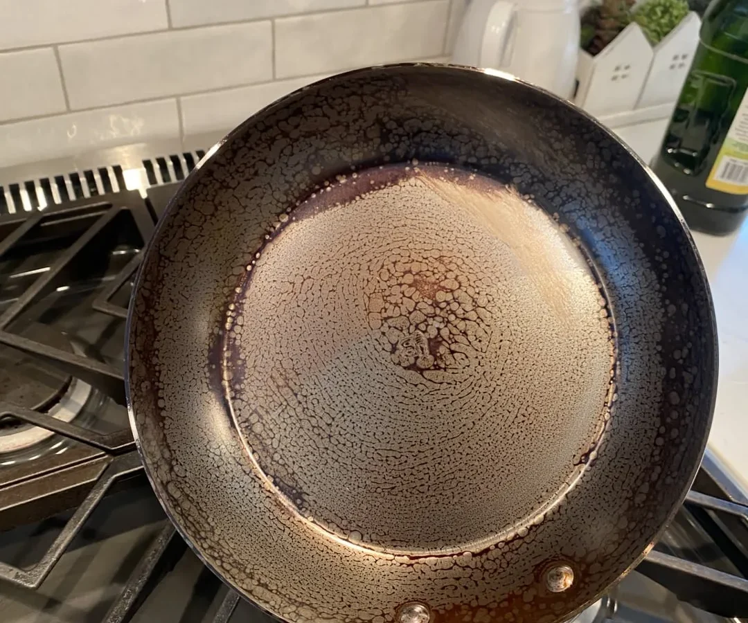 how to fix carbon steel skillet seasoning peeling off when cooking acidic lemon or tomato